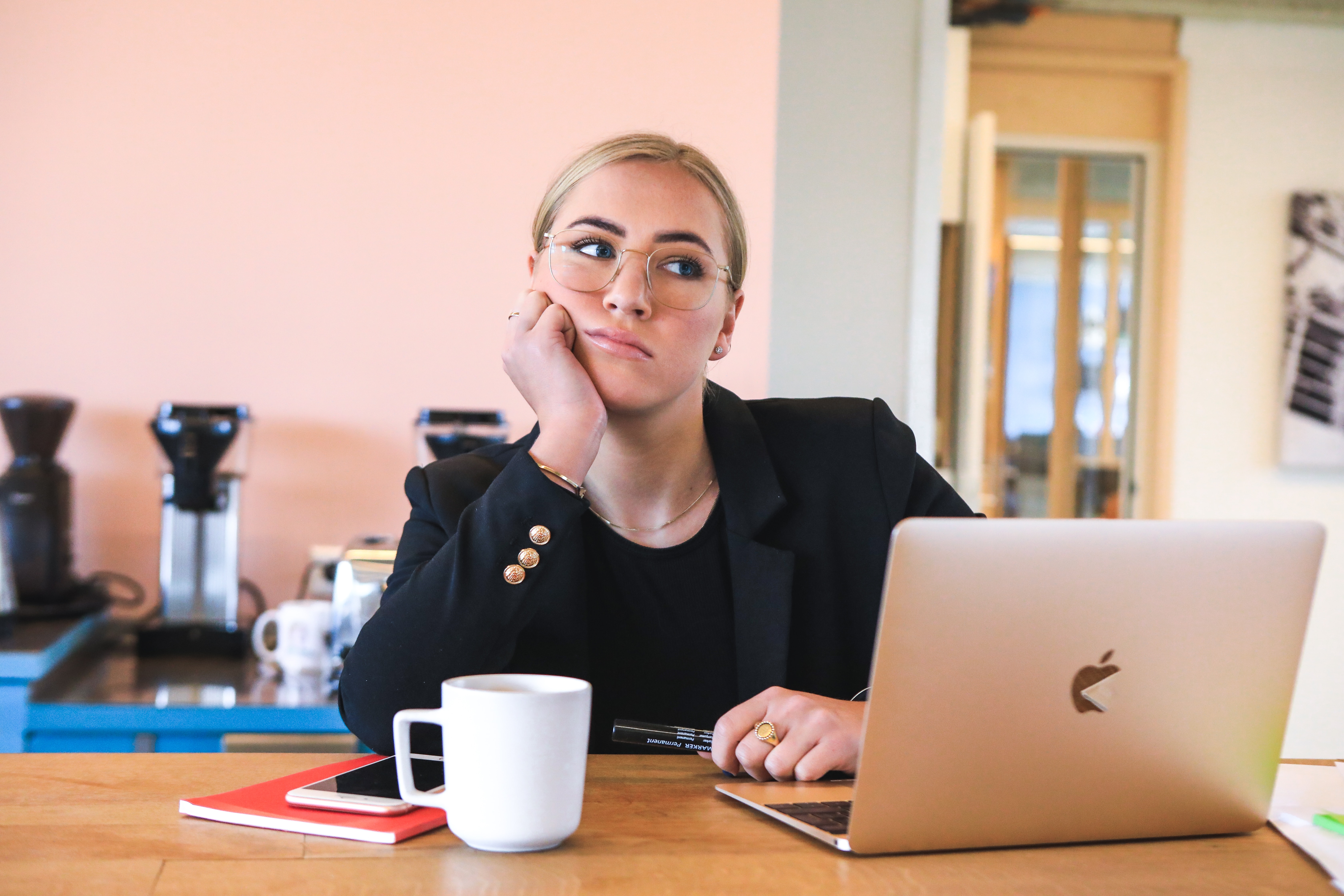 La procrastination: on voit une jeune femme blonde assise devant son ordinateur et qui ne semble pas motivée par la tâche qu'elle a à faire. 