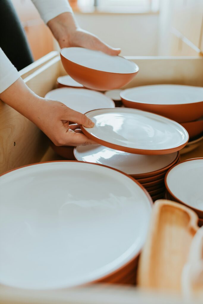 Organisation d’un tiroir de cuisine avec des assiettes et bols rangés par catégorie dans un espace bien structuré.